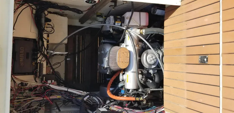 Slide: The Image of 1976 SeaCraft 23 Classic engine compartment with wiring and components. - 8