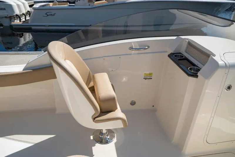 Slide: The Image of 2025 Scout 215 Dorado boat interior with beige seating and cup holders. - 10