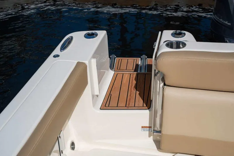 Slide: The Image of 2025 Scout 215 Dorado boat with teak swim platform and beige seating. - 13