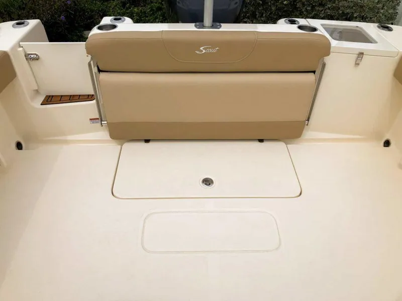 Slide: The Image of 2025 Scout 215 Dorado boat interior with beige seating and storage compartments. - 8