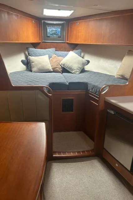 Slide: The Image of 2006 Topaz 40 Express cabin interior with cozy bed and wooden furnishings. - 11