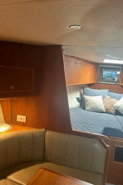 Slide: The Image of 2006 Topaz 40 Express yacht interior with cozy seating and bed. - 13