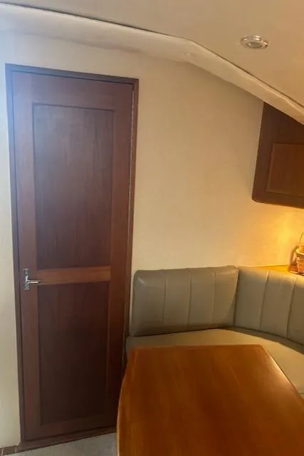 Slide: The Image of Interior of 2006 Topaz 40 Express yacht with wooden door and seating area. - 15
