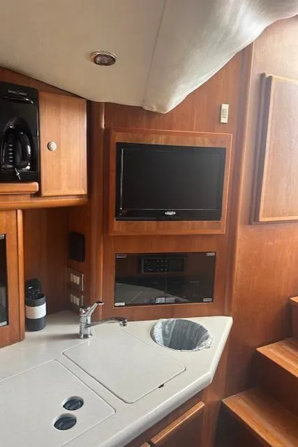 Slide: The Image of 2006 Topaz 40 Express yacht interior with TV and kitchenette. - 16