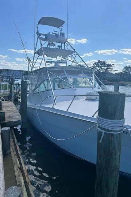 Slide: The Image of 2006 Topaz 40 Express boat docked at a marina on a sunny day. - 22
