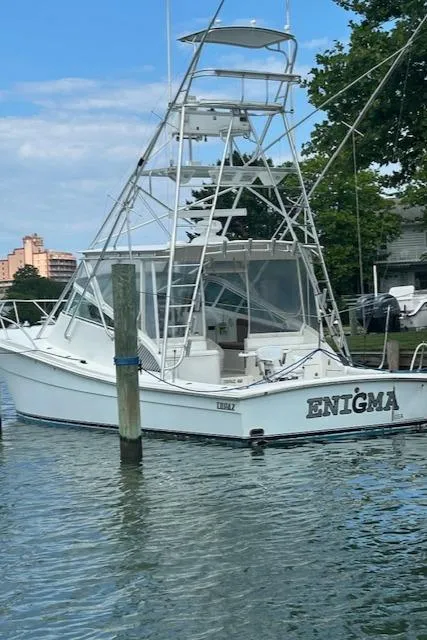 Slide: The Image of 2006 Topaz 40 Express boat named Enigma docked in a marina. - 23