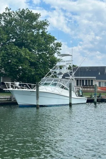 Slide: The Image of 2006 Topaz 40 Express boat docked at a marina. - 24