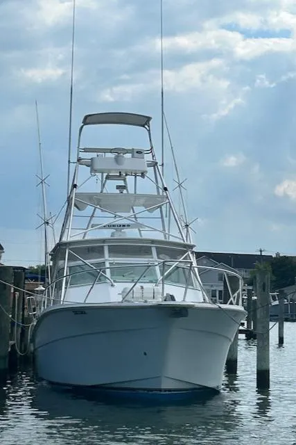 Slide: The Image of 2006 Topaz 40 Express boat docked at a marina. - 27