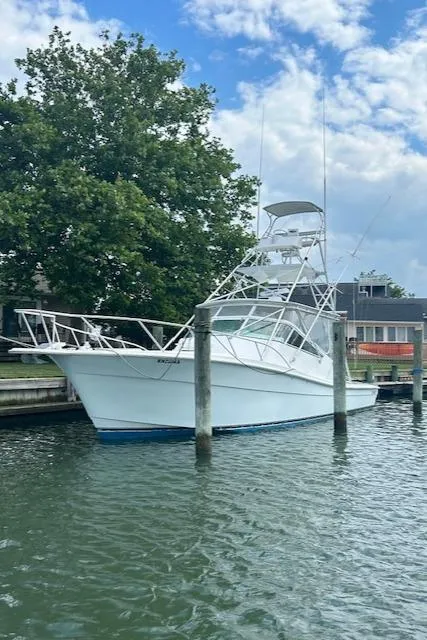 Slide: The Image of 2006 Topaz 40 Express boat docked in a marina. - 28