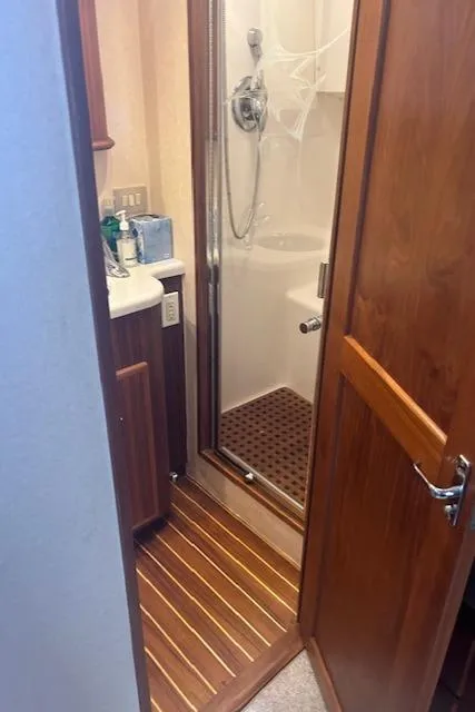 Slide: The Image of 2006 Topaz 40 Express yacht bathroom with wooden flooring and enclosed shower. - 3