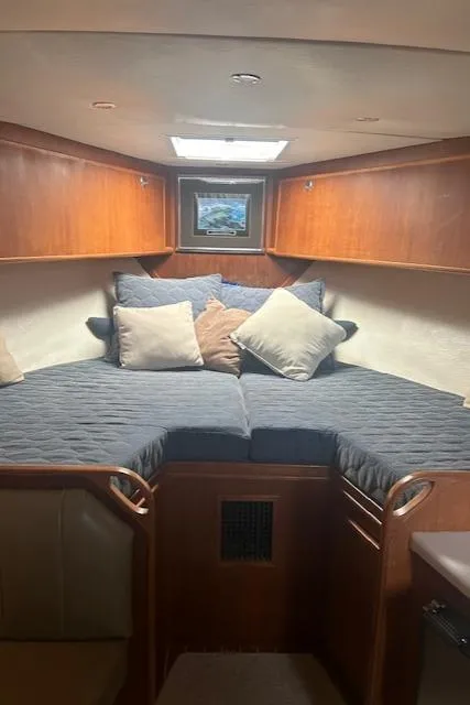 Slide: The Image of 2006 Topaz 40 Express cabin interior with cozy bedding and wooden cabinetry. - 5
