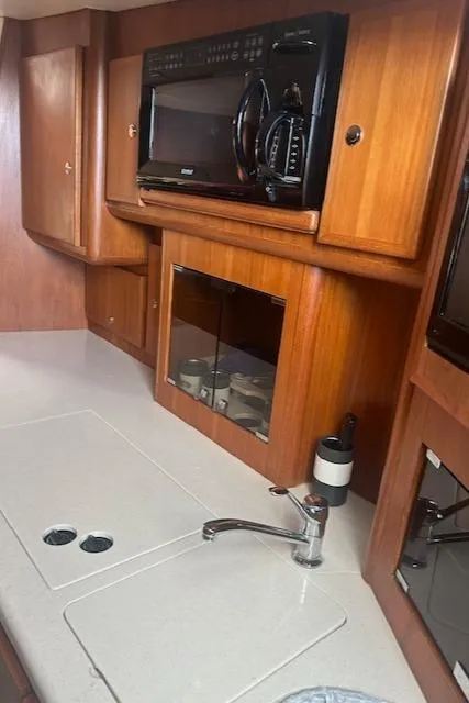 Slide: The Image of 2006 Topaz 40 Express yacht kitchen with microwave and sink - 7