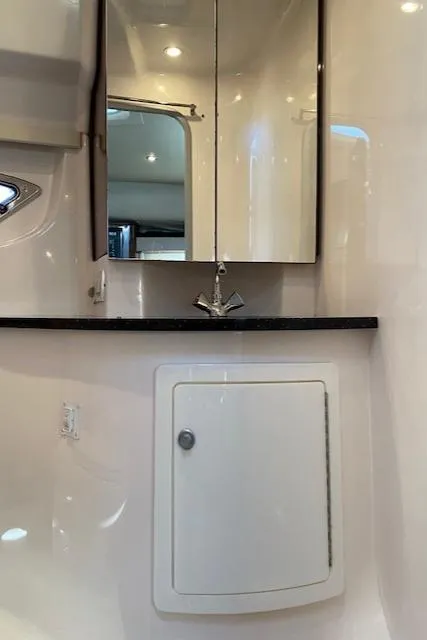 Slide: The Image of 2014 Regal 35 Sport Coupe bathroom with mirror, sink, and storage cabinet. - 10