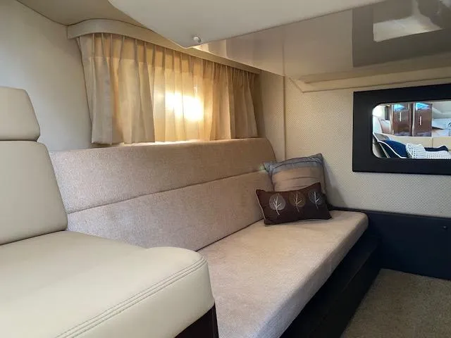 Slide: The Image of Interior of 2014 Regal 35 Sport Coupe with beige seating and decorative pillows. - 11