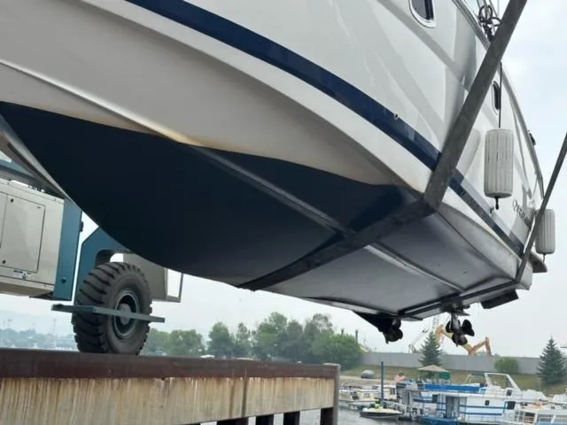 Slide: The Image of 2014 Regal 35 Sport Coupe boat being lifted at a marina. - 13