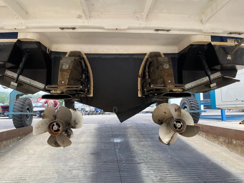 Slide: The Image of 2014 Regal 35 Sport Coupe boat propellers and stern view in maintenance area. - 15