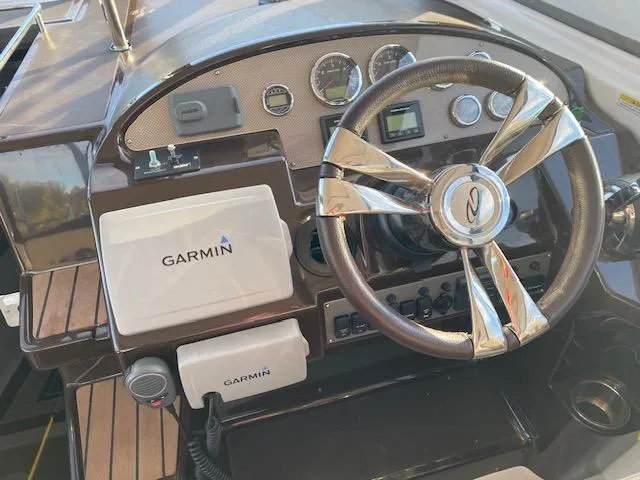 Slide: The Image of 2014 Regal 35 Sport Coupe helm with Garmin navigation system and modern controls. - 2