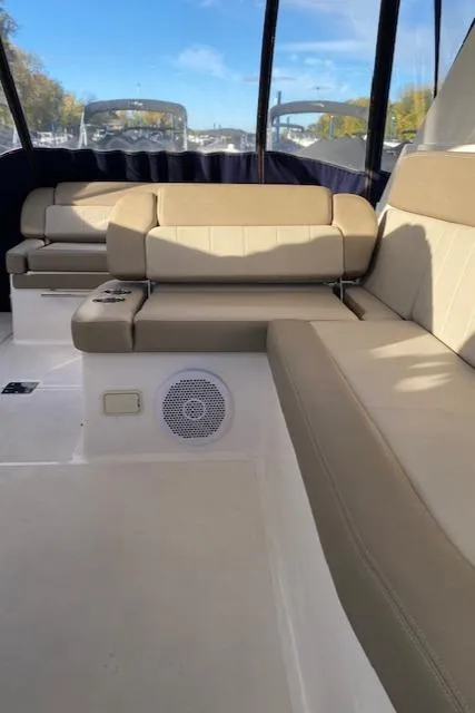 Slide: The Image of 2014 Regal 35 Sport Coupe interior with beige seating and speaker, showcasing luxury design. - 6