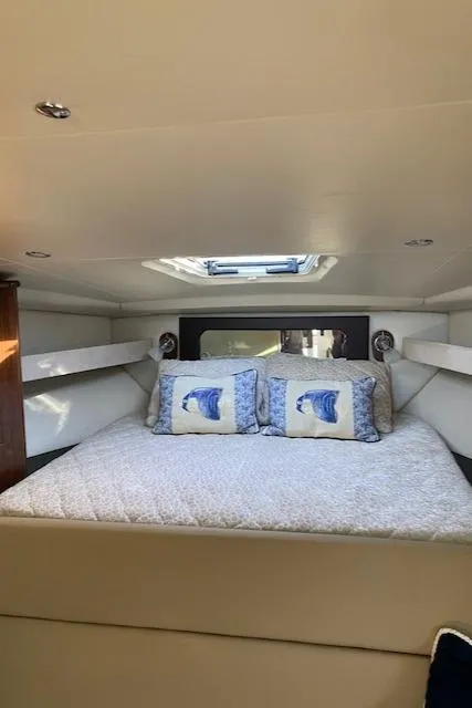 Slide: The Image of Interior cabin of 2014 Regal 35 Sport Coupe with cozy bedding and decorative pillows. - 8