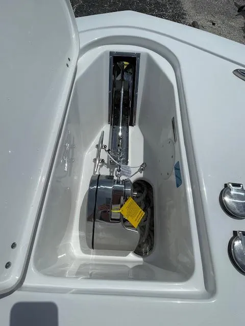 Slide: The Image of 2025 Tidewater 256 LXF boat anchor compartment with open hatch. - 15