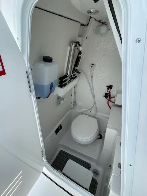 Slide: The Image of 2025 Tidewater 256 LXF boat interior bathroom with toilet and shower. - 18