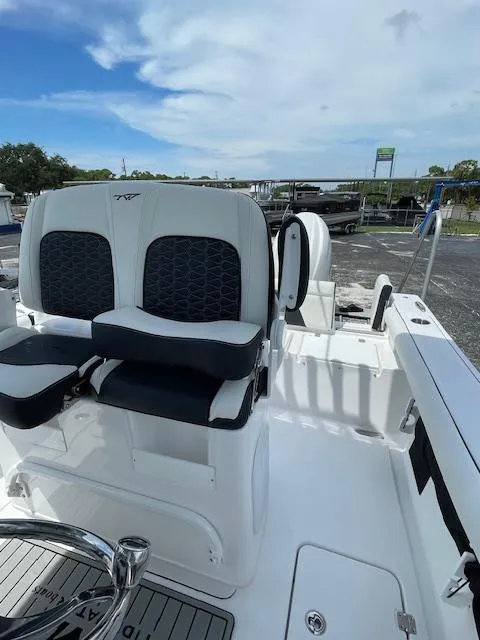 Slide: The Image of 2025 Tidewater 256 LXF boat interior with dual seating and sleek design. - 19