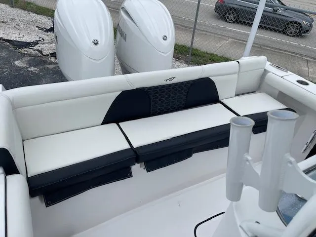 Slide: The Image of 2025 Tidewater 256 LXF boat with white seating and dual Yamaha engines. - 23