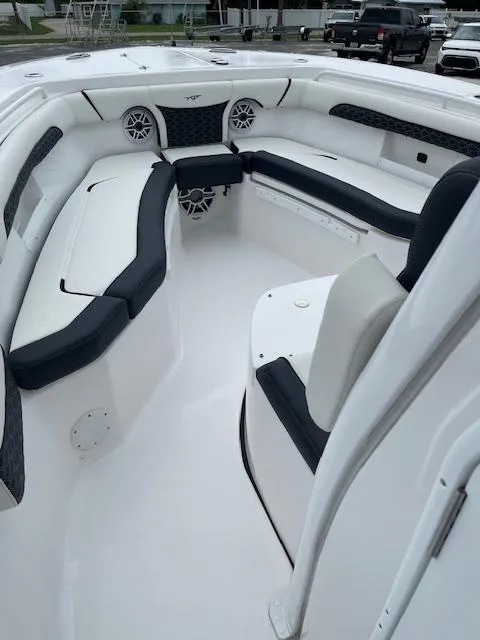 Slide: The Image of 2025 Tidewater 256 LXF boat interior with cushioned seating and modern design. - 26