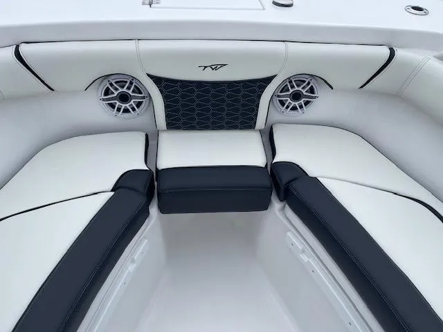 Slide: The Image of 2025 Tidewater 256 LXF boat interior with stylish seating and speakers. - 27