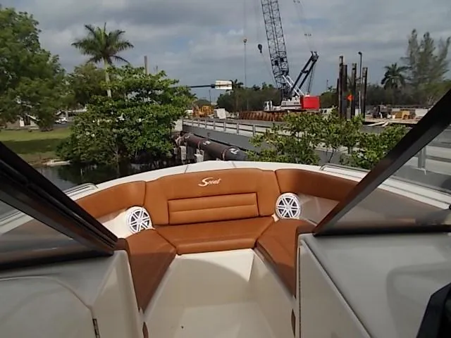 Slide: The Image of 2025 Scout 255 Dorado boat with tan seating and waterfront view. - 10