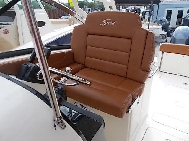 Slide: The Image of 2025 Scout 255 Dorado boat with brown leather captain's seat. - 12