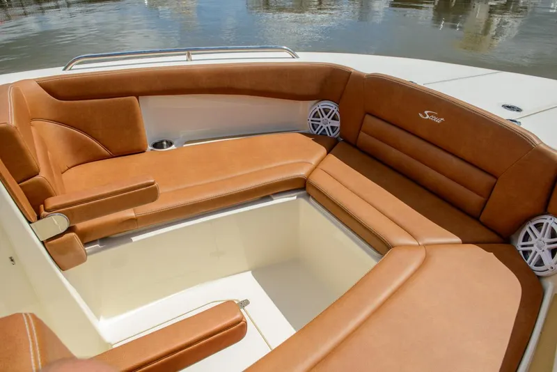 Slide: The Image of 2025 Scout 255 Dorado boat with luxurious tan leather seating and waterfront view. - 5