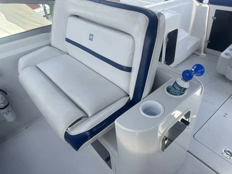 Slide: The Image of 1992 Four Winns 365 Express boat seat with cup holder and water bottle. - 11