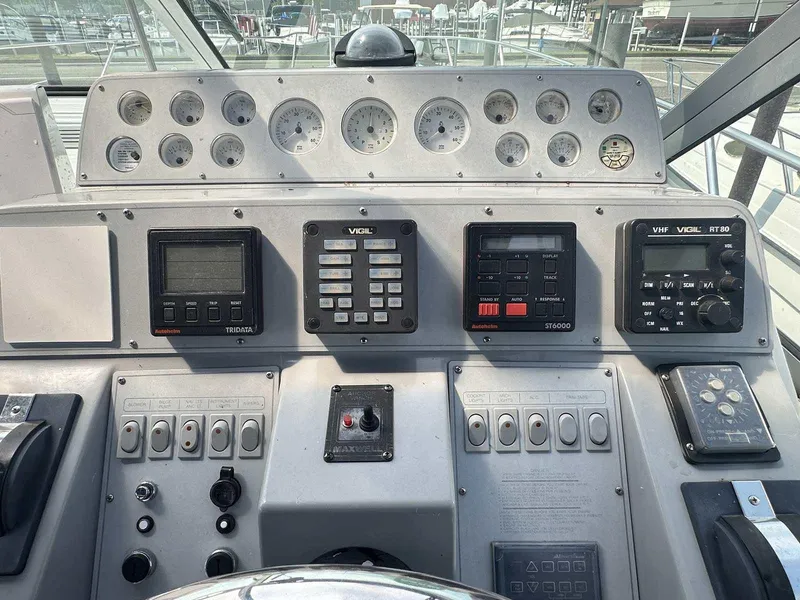Slide: The Image of Control panel of a 1992 Four Winns 365 Express boat with gauges and navigation equipment. - 13