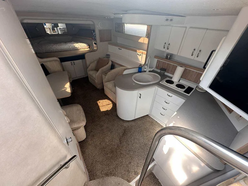 Slide: The Image of Interior of 1992 Four Winns 365 Express boat with kitchen, seating, and sleeping area. - 15