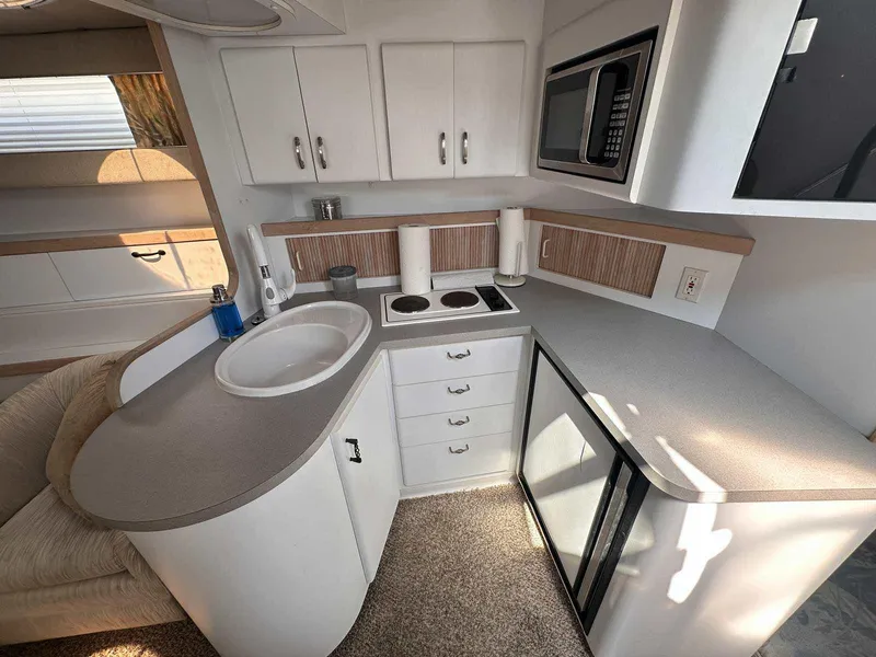 Slide: The Image of 1992 Four Winns 365 Express yacht kitchen with modern appliances and sleek cabinetry. - 17