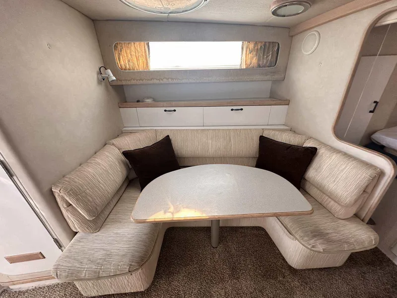 Slide: The Image of 1992 Four Winns 365 Express cabin interior with cozy seating and table. - 20
