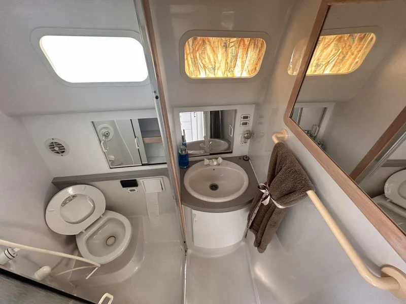 Slide: The Image of 1992 Four Winns 365 Express boat bathroom with sink, toilet, and mirror. - 22