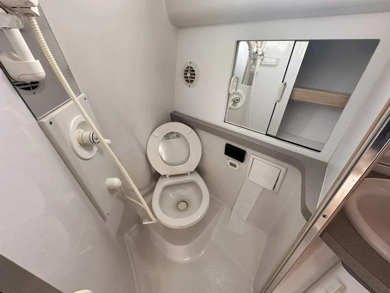 Slide: The Image of 1992 Four Winns 365 Express boat bathroom with toilet, shower, and mirror cabinet. - 23