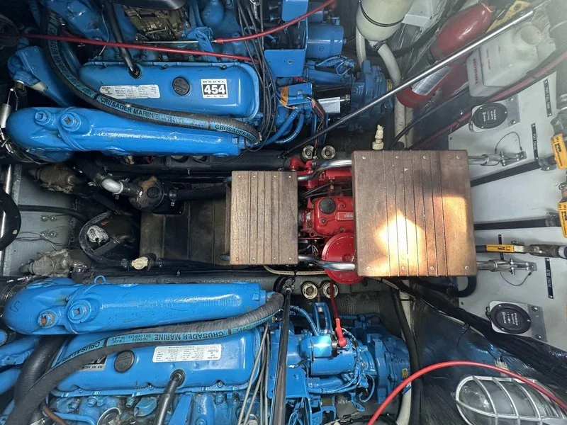 Slide: The Image of Engine room of a 1992 Four Winns 365 Express boat, featuring blue and red components. - 25