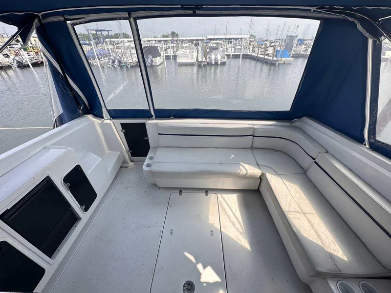 Slide: The Image of 1992 Four Winns 365 Express boat interior with white seating, docked at marina. - 7