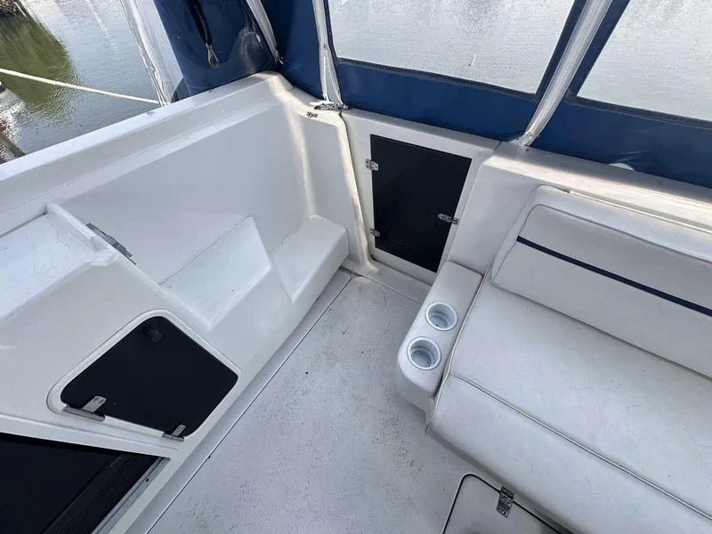 Slide: The Image of 1992 Four Winns 365 Express boat interior with seating and cup holders. - 8