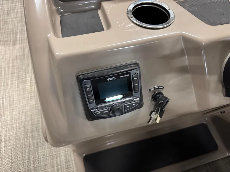 Slide: The Image of 2024 Ranger Reata 200C dashboard with stereo system and ignition keys. - 12