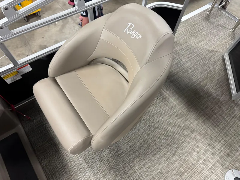 Slide: The Image of 2024 Ranger Reata 200C boat seat, beige leather, on textured flooring. - 13