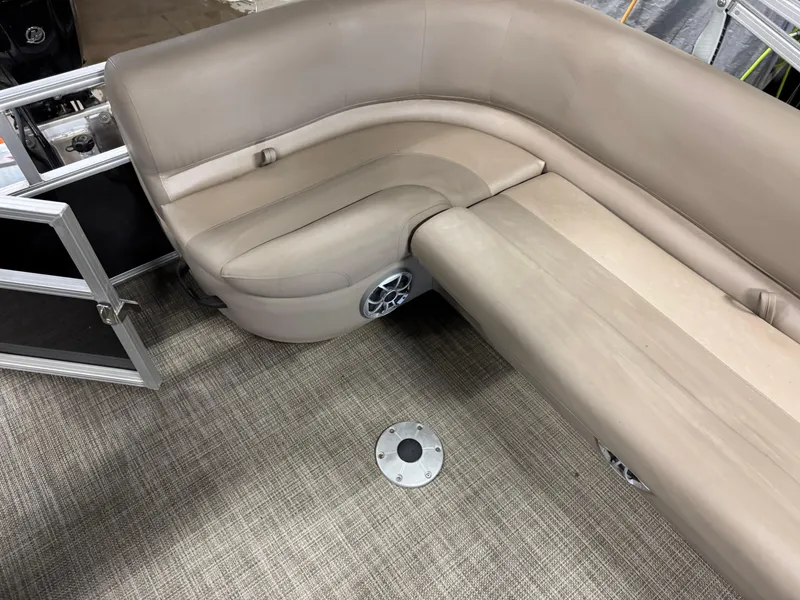 Slide: The Image of 2024 Ranger Reata 200C boat interior with beige seating and carpeted flooring. - 14