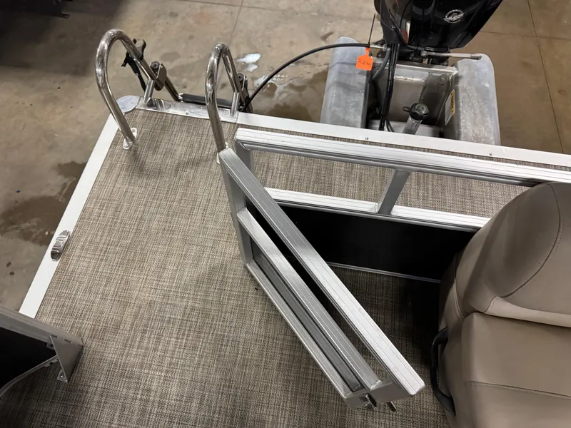 Slide: The Image of 2024 Ranger Reata 200C boat interior with open gate and motor view. - 15