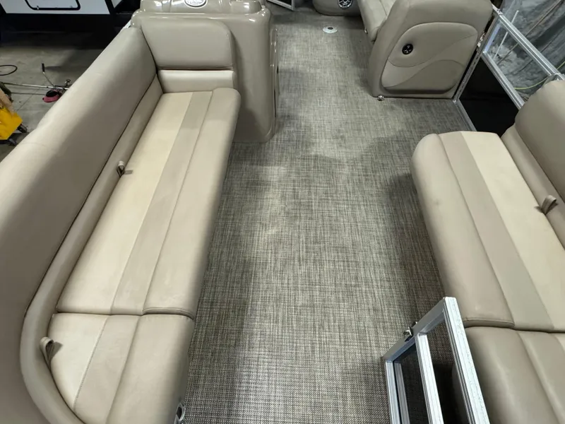 Slide: The Image of 2024 Ranger Reata 200C interior with beige seating and textured flooring. - 6