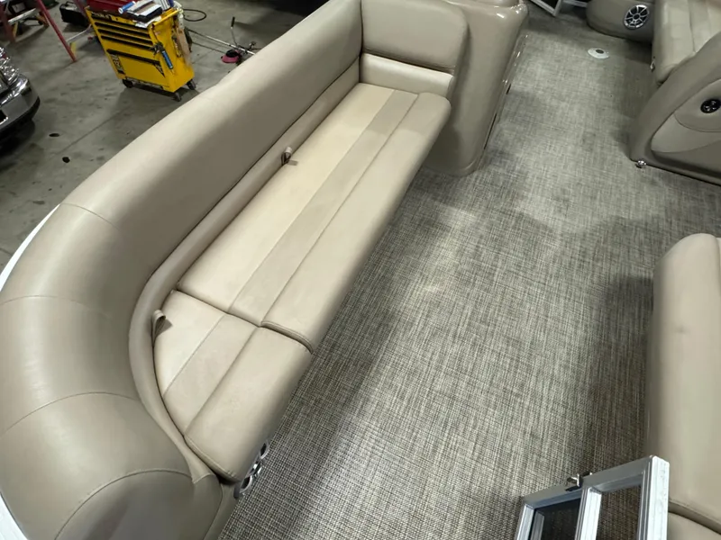 Slide: The Image of 2024 Ranger Reata 200C boat interior with beige seating and carpeted flooring. - 7