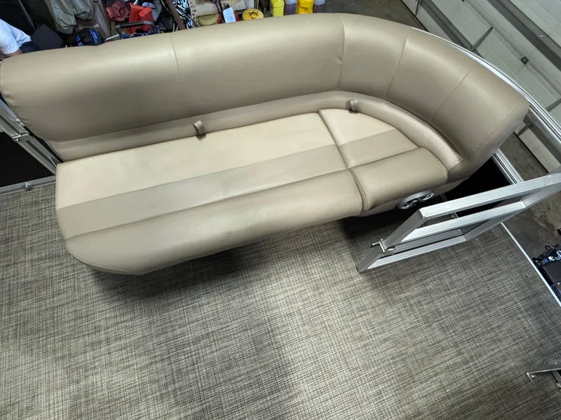 Slide: The Image of 2024 Ranger Reata 200C boat interior with beige seating and textured flooring. - 8