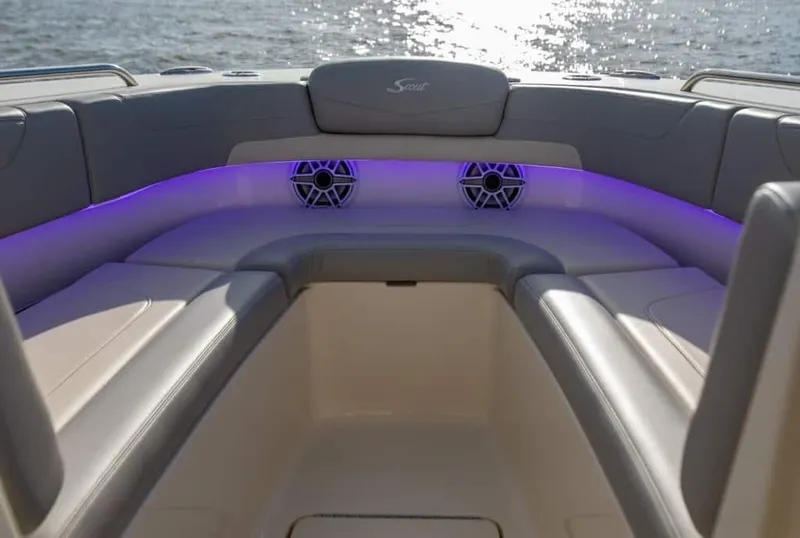 Slide: The Image of 2025 Scout 277 Dorado boat interior with purple LED lighting and cushioned seating. - 6